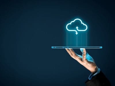 Phillips & co | our services 6 An accountant holding an ipad with a virtual cloud above.