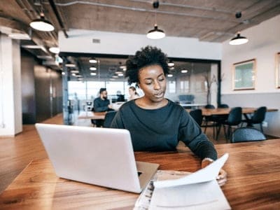 A small business owner looking through her bookkeeping records.